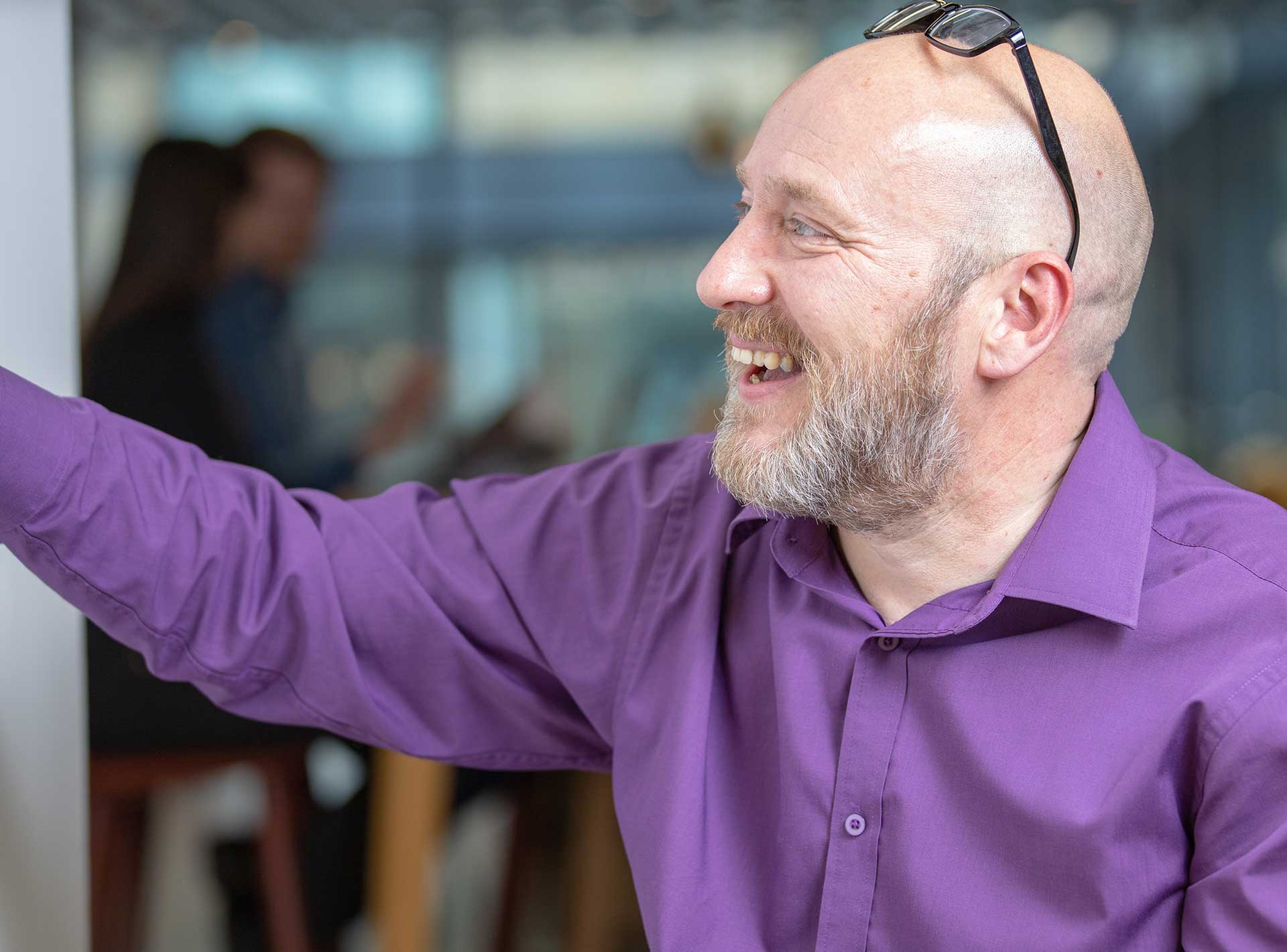 A man pointing to a whiteboard