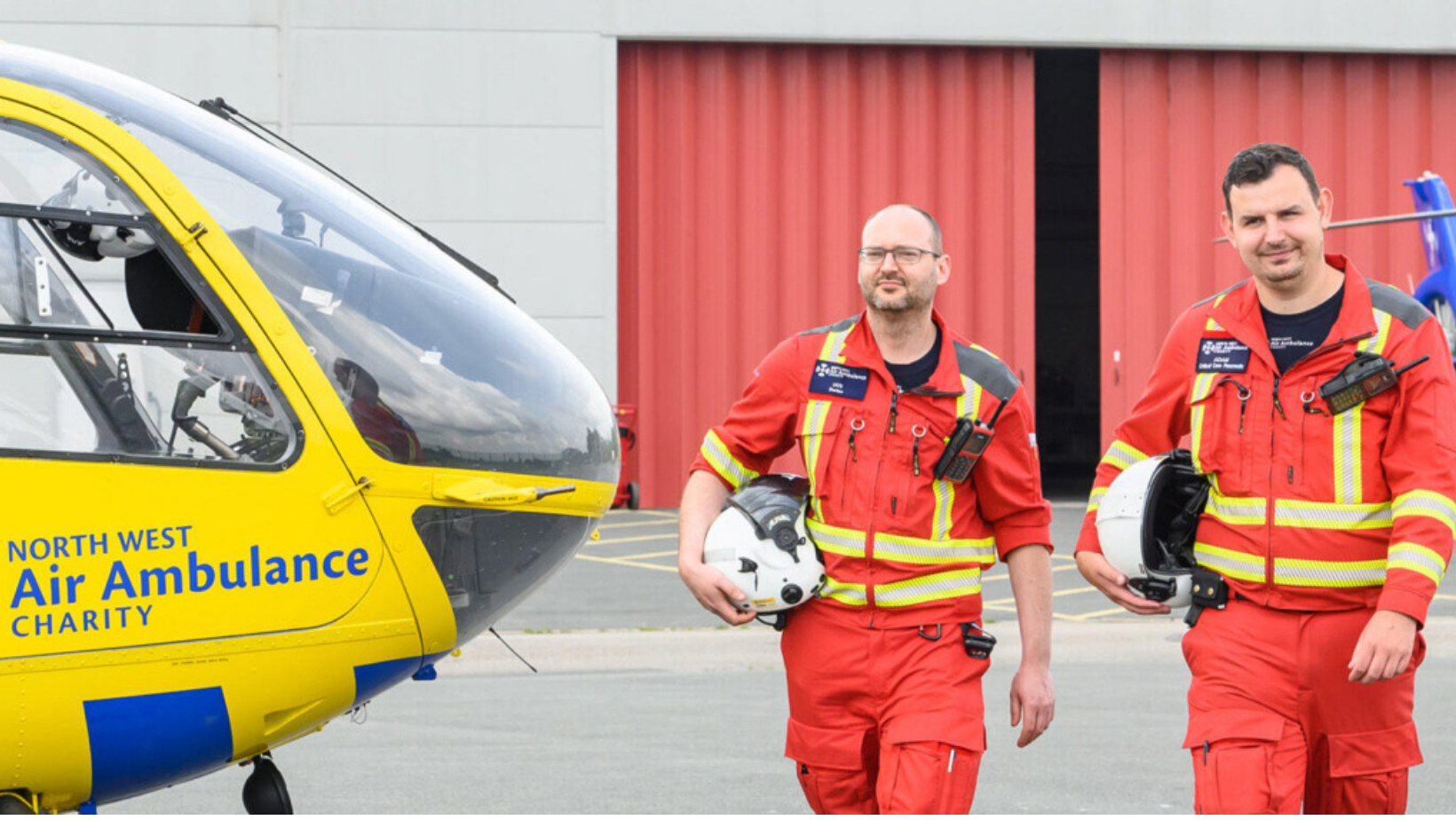 Helicopter with two paramedics standing side by side 